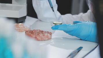 A person in a lab coat is holding a piece of food video