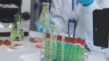 A scientist is working in a laboratory with some test tubes video