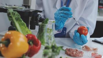 A person in a lab coat is holding a tomato video