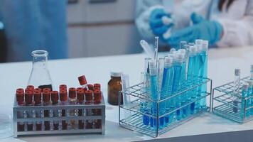 A laboratory with several test tubes and a person in a lab coat video