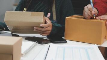 Two people are working on a computer with boxes video
