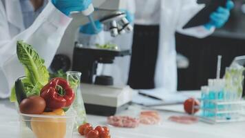 A scientist is using a microscope to look at vegetables video