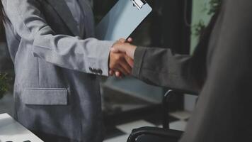 A business person shaking hands with another person video