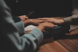 Two people holding hands at a table photo