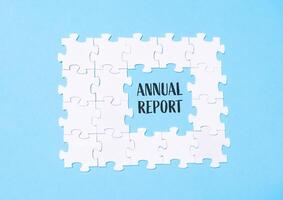 A jigsaw puzzle with the words Annual Report written in the middle photo