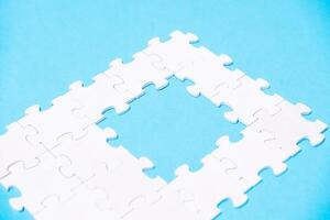 A puzzle piece is missing from a puzzle, leaving a gap in the middle photo