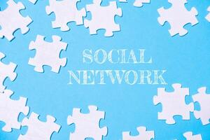 A jigsaw puzzle with the word social network written on it photo