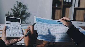 Business people working on financial documents video