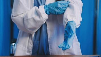 A person in a lab coat and blue gloves video