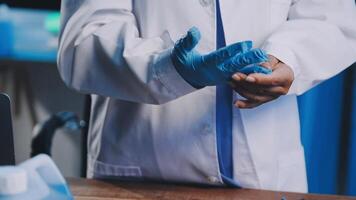 A person in a lab coat and blue gloves video