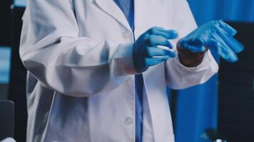 A man in a lab coat and gloves is holding something video