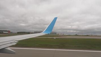 First person view of an airplane wing during acceleration and takeoff video