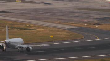 An airplane with an unrecognizable livery picks up speed and takes off. Sea in the background video