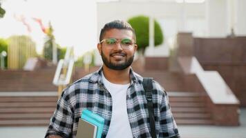 Handsome Indian Asian student walking after class in university campus video