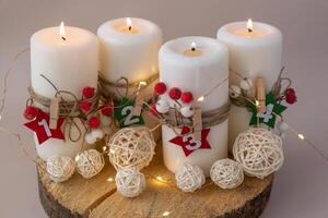 Traditional Burning Christmas Wax Candles with numbers counting down for Christmas New year and Christmas preparation. Four-week advent candles on table. Handmade eco-friendly decor. Sustainable Christmas decoration. Copy space photo