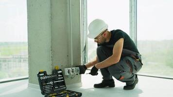 Electrician installing a wall socket video