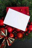 Copy space mock up template white paper sheet on postcard with envelope on handmade Christmas wreath. Zero waste eco-friendly Christmas. Sustainable greeting card decoration photo