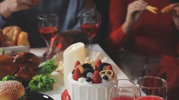 A table with a cake, fruit, and drinks video