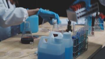 A person in a lab coat is working on a table video