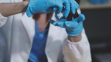 A woman in a lab coat is holding a small object video