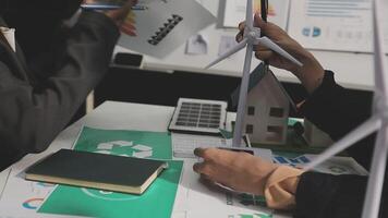 Two people working on a project with wind turbines video