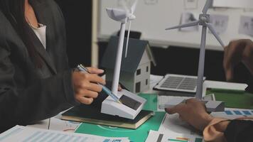 A man and woman are working on a wind turbine video