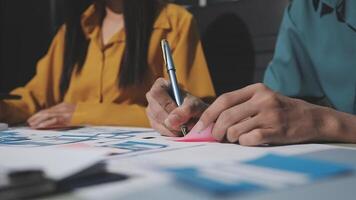 Two people working on a project with a pen video