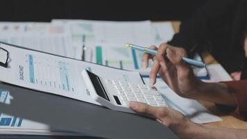 Businessman using calculator to calculate the cost of a project video