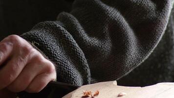Luthier working with a gouge in a new instrument video