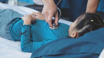 A child lying on a hospital bed with a stethoscope video