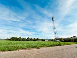 A 5G tower in a field on a sunny day. photo