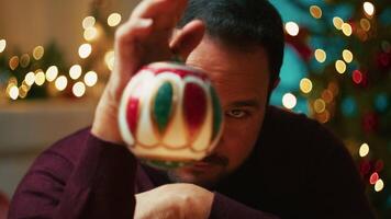 Young Man Plays With Christmas Ball Smiling Happy Near The Tree video