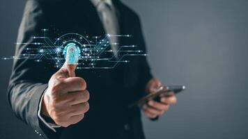 Businessman protecting personal data on finger print with virtual screen interfaces. Cyber security and privacy concepts to protect data. Lock icon and internet network security technology photo