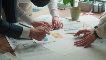 Office teamwork discussion architecture blueprints draw building plan construction design project on desk multiracial group architects engineers builders business man women coworkers paperwork analyze video