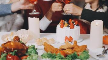 A group of people toasting with wine at a thanksgiving dinner video
