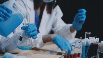 Two people in lab coats and gloves are working on a project video