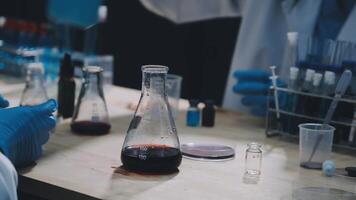 Two people in lab coats are working on a project video