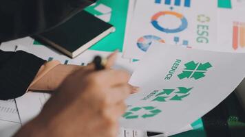 A person is working on a paper with green and white paper video
