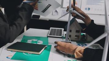 Two people working on a project with wind turbines video