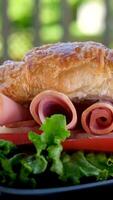 Ultra macro view of croissant with ham, lettuce and cheese, healthy breakfast video