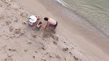 Top view of a family relaxing on the beach video