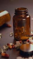 A Glass Jar Filled with an Assortment of Different Pills and Capsules Sitting on a Table video