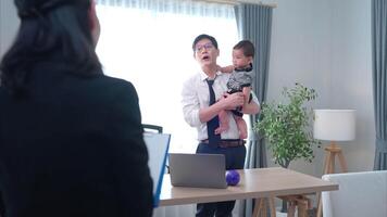 A business father assigns work to his secretary, while also taking care of his child while working video
