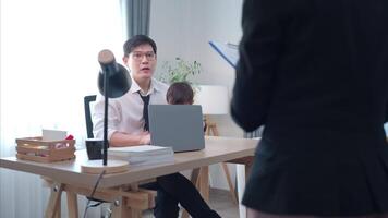 A business father assigns work to his secretary, while also taking care of his child while working video