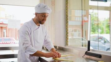 Baker Rolling Dough into Rolls, Baking Process Making Croissant. Concept for Bakery video