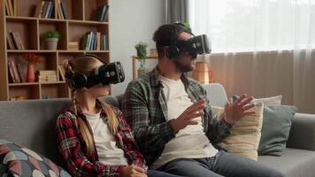 Curious Caucasian parent man dad guy male father using vr virtual reality headset glasses little schoolgirl child girl daughter kid exploring 3d world game metaverse cyberspace at home AR technology video