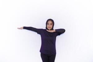 a woman in a purple shirt is doing a stretch photo