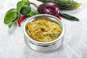 A silver container with food on a table photo