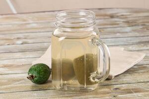 A glass jar with a green apple in it photo