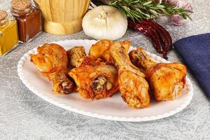 A plate of chicken wings on a table with spices photo